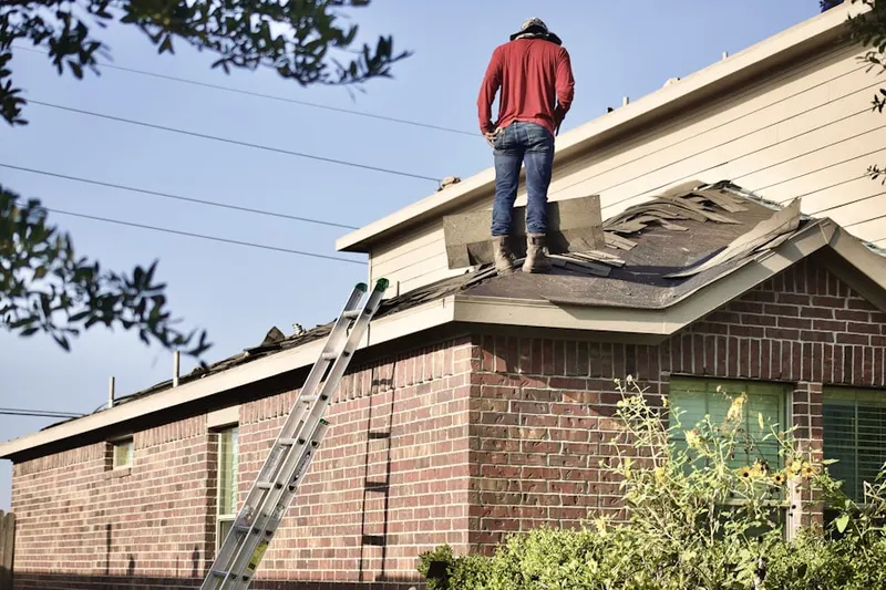 Professional roofer working on a residential roof in Sunrise Ranch